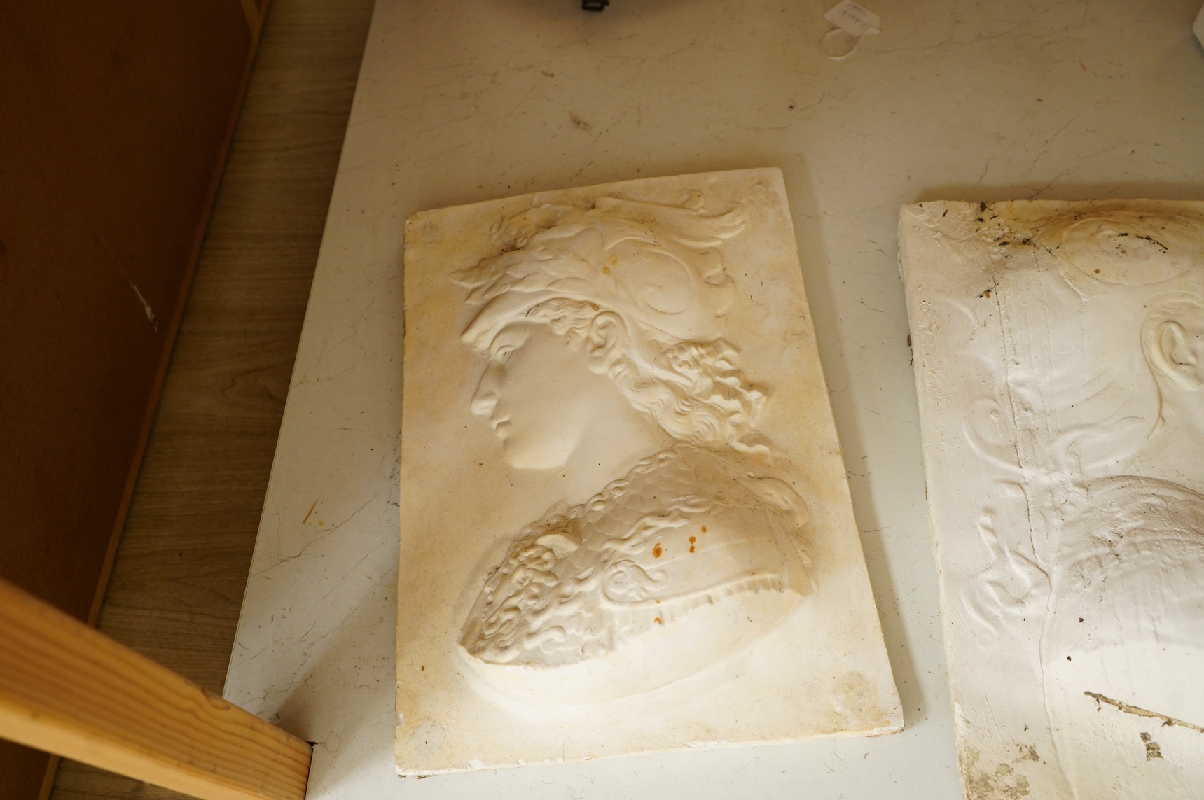 A collection of plaster-cast relief panels to include classical busts and foliage, largest 47cm high